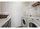 Functional laundry room with modern washer and dryer units at 11046 Pastel Pt, Parker, CO 80134