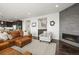 Cozy living room features a leather sofa, a modern fireplace, and an open-concept layout at 11046 Pastel Pt, Parker, CO 80134