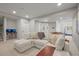 Comfortable living room with plush sectional sofa, wall-mounted desk, and foosball table at 11046 Pastel Pt, Parker, CO 80134