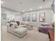 Spacious living room with a large sectional sofa, oversized beanbag chair, and art at 11046 Pastel Pt, Parker, CO 80134