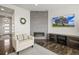 Modern living room with a fireplace, a comfortable armchair, and a sleek entertainment center at 11046 Pastel Pt, Parker, CO 80134