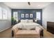 Beautifully decorated main bedroom featuring an accent wall, bench and shutters at 11046 Pastel Pt, Parker, CO 80134