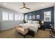 Beautifully decorated main bedroom featuring an accent wall, bench and shutters at 11046 Pastel Pt, Parker, CO 80134