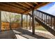 Under-deck patio featuring a concrete floor, wooden beams, landscaping, and stairs to the yard at 11046 Pastel Pt, Parker, CO 80134