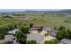 Aerial view of the property showcasing the home's location in a verdant neighborhood with rolling hills and mountain views at 4099 Starflower Rd, Castle Rock, CO 80109