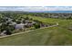 Picturesque aerial view of homes adjacent to a vast green field and walking trails at 4099 Starflower Rd, Castle Rock, CO 80109