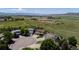 Aerial view showcasing homes in a cul-de-sac neighborhood near green fields and distant mountains at 4099 Starflower Rd, Castle Rock, CO 80109