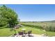 Serene backyard with lush lawn, mature trees, stone patio, and views of a picturesque pasture at 4099 Starflower Rd, Castle Rock, CO 80109