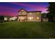 The backyard features a well-kept lawn, patio, and storage shed under a vivid dusk sky at 4099 Starflower Rd, Castle Rock, CO 80109