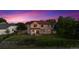 Backyard view featuring lush lawn, patio with seating, storage shed, and gorgeous dusk sky at 4099 Starflower Rd, Castle Rock, CO 80109