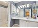 Bathroom featuring a blue accent wall, white cabinets, and a shower with a white curtain at 4099 Starflower Rd, Castle Rock, CO 80109