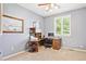 Bedroom featuring a corner desk, shelving unit, large window, and neutral carpet at 4099 Starflower Rd, Castle Rock, CO 80109