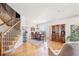 Bright dining room with hardwood floors, elegant furniture, staircase, and large windows at 4099 Starflower Rd, Castle Rock, CO 80109