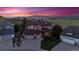 Stunning two-story home with a three-car garage, mature landscaping, and mountain views at sunset at 4099 Starflower Rd, Castle Rock, CO 80109