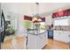 Eat-in kitchen with center island, granite counters, stainless appliances, and adjacent living area at 4099 Starflower Rd, Castle Rock, CO 80109
