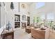 Inviting living room with vaulted ceilings, built-in shelving, a cozy fireplace, and large windows at 4099 Starflower Rd, Castle Rock, CO 80109