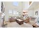 Bright living room features high ceilings, large windows with shutters, and comfortable furnishings at 4099 Starflower Rd, Castle Rock, CO 80109