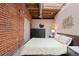 Cozy bedroom featuring exposed brick wall and a large window at 1515 N Ogden St # 7, Denver, CO 80218