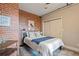 Bedroom with brick wall, modern decor, and a closet at 1515 N Ogden St # 7, Denver, CO 80218
