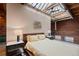 Bright bedroom features exposed brick, a skylight, and a modern industrial design at 1515 N Ogden St # 7, Denver, CO 80218