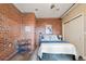 Bedroom with exposed brick wall, neutral bedding, and modern decor at 1515 N Ogden St # 7, Denver, CO 80218