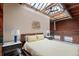 Spacious bedroom featuring a skylight, exposed brick, and modern decor elements, offering a unique industrial-chic aesthetic at 1515 N Ogden St # 7, Denver, CO 80218