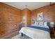 Bedroom with exposed brick accent wall, neutral bedding, and modern decor at 1515 N Ogden St # 7, Denver, CO 80218