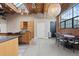 Bright living room features hardwood floors, modern lighting, exposed brick, and large windows at 1515 N Ogden St # 7, Denver, CO 80218