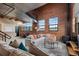 Open concept living space features exposed brick walls, high ceilings, and industrial chic finishes at 1515 N Ogden St # 7, Denver, CO 80218