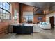Open concept living space features exposed brick walls, high ceilings, and industrial chic finishes at 1515 N Ogden St # 7, Denver, CO 80218