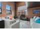 Bright living room with exposed brick, high ceilings, and large windows, offering ample natural light at 1515 N Ogden St # 7, Denver, CO 80218