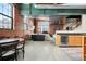 Open-concept living area featuring exposed brick, large windows, and a stylish kitchen with a wine fridge at 1515 N Ogden St # 7, Denver, CO 80218