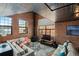 Cozy living room features exposed brick, a pressed tin ceiling, and a modern fireplace at 1515 N Ogden St # 7, Denver, CO 80218
