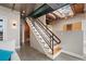 Staircase to upper level with metal railings, wooden steps, and views of the kitchen at 1515 N Ogden St # 7, Denver, CO 80218