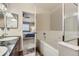 Bathroom features a tiled floor, a white tub and view to the main bedroom at 1897 S Buchanan Cir, Aurora, CO 80018