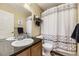 Bathroom featuring modern design with decorative shower curtain and updated sink at 1897 S Buchanan Cir, Aurora, CO 80018