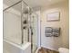 Bathroom with a glass shower stall and a decorative wall painting at 1897 S Buchanan Cir, Aurora, CO 80018
