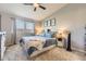Comfortable bedroom features a ceiling fan, window, and light gray carpet at 1897 S Buchanan Cir, Aurora, CO 80018