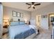 Well-lit bedroom with gray carpet and access to the en-suite bathroom at 1897 S Buchanan Cir, Aurora, CO 80018