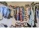 Walk-in closet is fully stocked with lots of clothes and shoes at 1897 S Buchanan Cir, Aurora, CO 80018