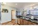 Spacious kitchen featuring a stainless steel dishwasher and granite countertops at 1897 S Buchanan Cir, Aurora, CO 80018