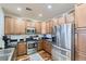 Updated kitchen with stainless steel appliances and light wood cabinets at 1897 S Buchanan Cir, Aurora, CO 80018
