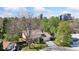 Aerial view of the home and surrounding neighborhood, with mature trees and city views at 8484 E Radcliff Ave, Denver, CO 80237