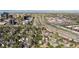 An aerial view of the community shows a freeway nearby and a variety of single Gathering homes at 8484 E Radcliff Ave, Denver, CO 80237