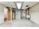 The basement features concrete flooring and walls as well as the utilities for the home at 8484 E Radcliff Ave, Denver, CO 80237