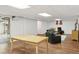 The basement features an open floor plan with wooden floors and comfortable seating arrangements at 8484 E Radcliff Ave, Denver, CO 80237