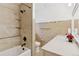 The bathroom offers modern fixtures, a tiled shower and bath, and a vanity with a marble top at 8484 E Radcliff Ave, Denver, CO 80237