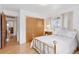 Cozy bedroom featuring hardwood floors, natural light, and closet with sliding doors at 8484 E Radcliff Ave, Denver, CO 80237