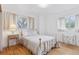 Comfortable bedroom with hardwood floors, two windows, and a well-lit, inviting atmosphere at 8484 E Radcliff Ave, Denver, CO 80237