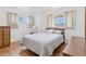 Inviting bedroom with hardwood floors, large windows and matching furniture creating a serene atmosphere at 8484 E Radcliff Ave, Denver, CO 80237
